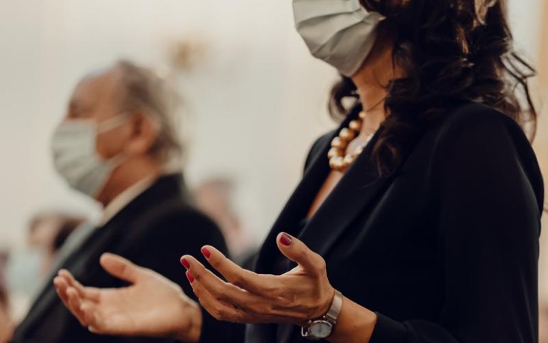 Masked woman praying