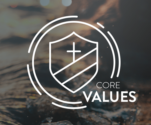 A white icon depicting a shield with a cross on it next to the words "Core Values"