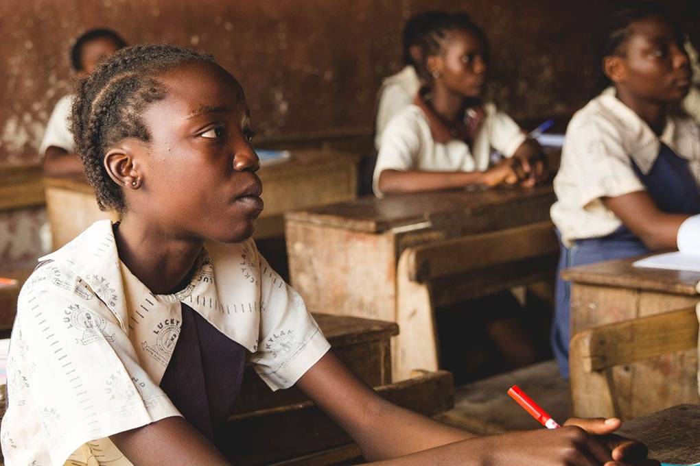 girl at desk in classroom.
